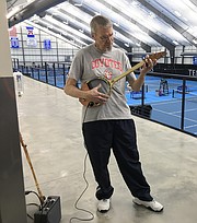 Scott Weir, of Topeka, plays his electric guitar made from a tennis racket on Feb. 2, 2018, which was the final day of the first session of senior tennis classes at the Jayhawk Tennis Center, 233 Rock Chalk Lane.