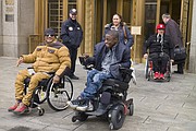 Maurice Evans, left, Blake Hunt, center, and Angel Martinez leave federal court after attending a hearing Wednesday, Feb. 14, 2018, in New York. The three attended to show their support for a lawsuit that claims the government's decision to classify marijuana as dangerous is irrational, unconstitutional and motivated by politics, not hard science. (AP Photo/Mark Lennihan)