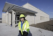 Melinda Harger, utilities engineer with the City of Lawrence, passes by the new administration building at the new Wakarusa Wastewater Treatment Plant, 2300 E. 41st St., Tuesday, Feb. 13, 2018.