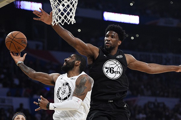 Team LeBron's Kyrie Irving, left, of the Boston Celtics, shoots as Team Stephen's Joel Embiid, of the Philadelphia 76ers, defends during the first half of an NBA All-Star basketball game, Sunday, Feb. 18, 2018, in Los Angeles. (AP Photo/Chris Pizzello)