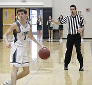 High school basketball official Mark Samsel does a 5-second count while watching the ball in Saturday's game between Free State and Bishop Miege at FSHS.