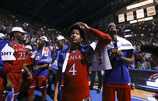 Kansas guard Devonte' Graham (4) watches a highlight video with his teammates following their 80-70 win over Texas on Monday, Feb. 26, 2018 at Allen Fieldhouse. The win gave the Jayhawks an outright win of their 14th-straight Big 12 Conference title.