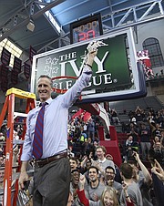 Pennsylvania's head coach Steve Donahue makes the final cut of the net following an NCAA college basketball championship game in the Ivy League Tournament against the Harvard, Sunday, March 11, 2018, in Philadelphia. Penn won 68-65. (AP Photo/Chris Szagola)