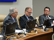 Kansas State Board of Education member Ken Willard, left, discusses the issue of allowing some school employees, including teachers, to carry firearms as part of an effort to ward off mass shootings as board members John Bacon, center, and Steve Roberts listen, Tuesday, March 13, 2018.