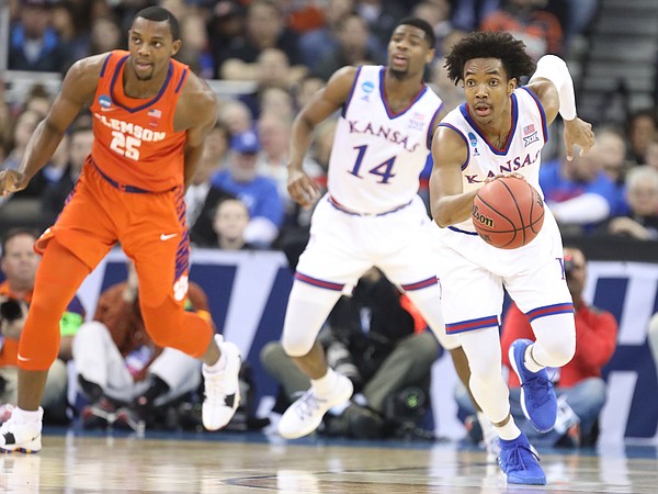 Kansas guard Devonte' Graham (4) runs up the court with the ball during the first half, Friday, March 23, 2018 at CenturyLink Center in Omaha, Neb.