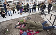 British artist Paul Harfleet photographs a pansy that he planted just north of the Spencer Museum of Art on the campus of the University of Kansas, Friday, April 6, 2018. Harfleet, who is the creator of the Pansy Project, planted several pansies in various spots on the KU campus associated with homophobic abuse or homophobic incidents.