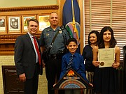 Gov. Jeff Colyer on Thursday presented Kansas Highway Patrol Technical Trooper Raul Carrillo with an Award for Valor in recognition of his actions Feb. 21 when he rescued a man from a burning truck following a rollover accident on the Kansas Turnpike in Butler County. Also pictured are Carrillo's son Esai, his wife Lydia, and daughter Aneesa.