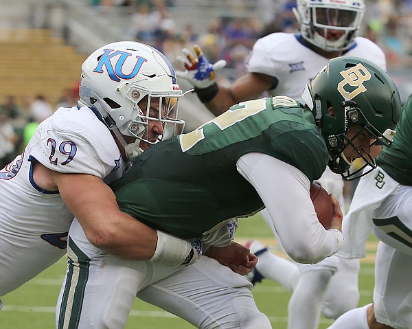 Baylor quarterback Charlie Brewer (12) is tackled by Kansas linebacker Joe Dineen Jr. (29) during the first half of an NCAA college football game, Saturday, Sept. 22, 2018, in Waco, Texas.