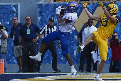Kansas cornerback Hasan Defense (13) intercepts a pass in the end zone during intended for West Virginia wide receiver David Sills V (13) during the first half of an NCAA college football game in Morgantown, W. Va., Saturday Oct. 6, 2018. (Craig Hudson/Charleston Gazette-Mail via AP)