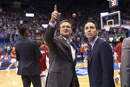 Kansas head coach Bill Self catches up with Washburn head coach Brett Ballard prior to tipoff of an exhibition, Thursday, Nov. 1, 2018, at Allen Fieldhouse.