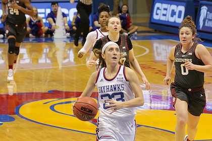 Kansas senior Kylee Kopatich (33) drives to the basket in a game against Oklahoma Wednesday night at Allen Fieldhouse. KU won 88-79.
