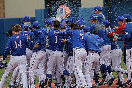 Kansas redshirt-freshman Dylan Ditzenberger is showered with water after hitting the game winning single in the bottom of the ninth against Oklahoma State at Hoglund Ballpark, April 13, 2019.