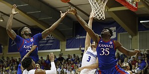 Kansas forward Silvio De Sousa (22) and center Udoka Azubuike (35) for for a rebound over Chaminade guard Kendall Small (25) and forward Eliet Donley (3) during an NCAA college basketball game Monday, Nov. 25, 2019, in Lahaina, Hawaii. (AP Photo/Marco Garcia)