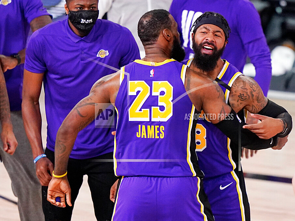 Los Angeles Lakers' forward LeBron James (23) celebrates with Markieff Morris (88) during a timeout in the second half of an NBA conference final playoff basketball game against the Denver Nuggets on Saturday, Sept. 26, 2020, in Lake Buena Vista, Fla. (AP Photo/Mark J. Terrill)

