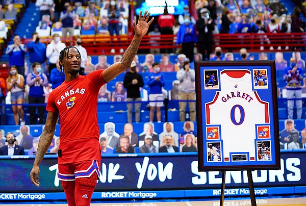 Kansas guard Marcus Garrett waves to the crowd as he is honored before tipoff on Senior Night, Saturday, Feb. 27, 2021 at Allen Fieldhouse.