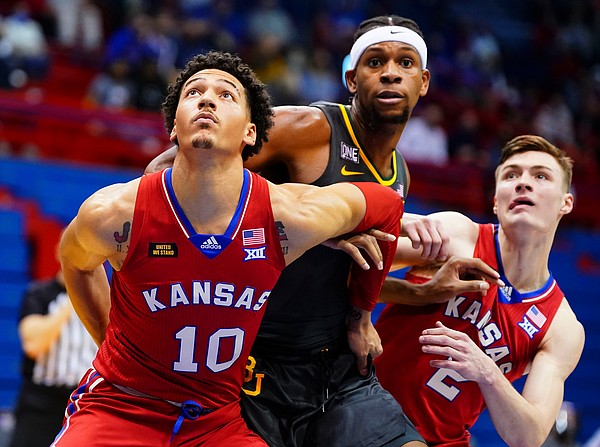 Kansas forward Jalen Wilson (10) and Kansas guard Christian Braun (2) box out Baylor forward Flo Thamba (0) during the second half on Saturday, Feb. 27, 2021 at Allen Fieldhouse.