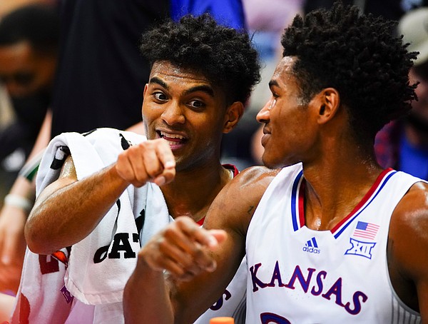 Kansas guard Remy Martin (11) and Kansas guard Ochai Agbaji (30) have a laugh on the bench during the second half on Wednesday, Nov. 3, 2021 at Allen Fieldhouse.
