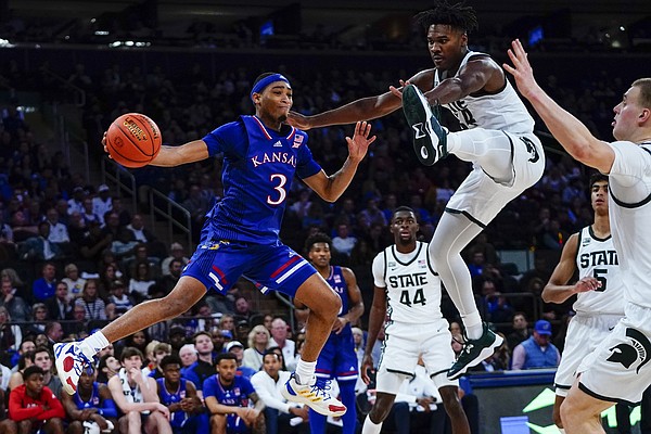 Kansas' Dajuan Harris (3) passes away from Michigan State's Julius Marble II (34) during the second half of an NCAA college basketball game Tuesday, Nov. 9, 2021, in New York. Kansas won the game 87-74. (AP Photo/Frank Franklin II)
