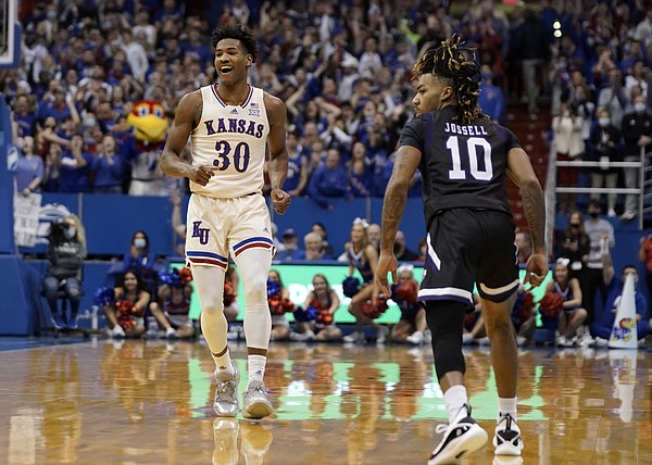 Kansas guard Ochai Agbaji (30) smiles after a three pointer over Stephen F. Austin guard Latrell Jossell (10) during the first half on Saturday, Dec. 18, 2021 at Allen Fieldhouse.