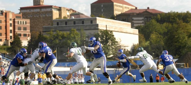 Underneath the backdrop of the Kansas University skyline, the Jayhawk offensive line provides just enough cover for quarterback Todd Reesing (5) to scramble against Baylor.