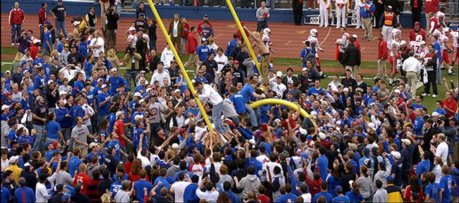 Jayhawk fans storm the field in this Journal-World file photo to tear down the goal posts after Kansas' 40-15 win over Nebraska at Memorial Stadium in 2005.