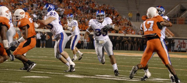 Kansas University's Brandon McAnderson (35) runs through a gaping hole in the Oklahoma State defense, between blocks from tight end Derek Fine (85) and wide receiver Dexton Fields, right. KU receivers have been counted on to block this season, often with good results.