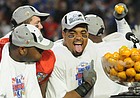 Kansas University running back Brandon McAnderson hams it up for the cameras with defensive end James McClinton after KU's 24-21 victory Thursday at the Orange Bowl in Miami.