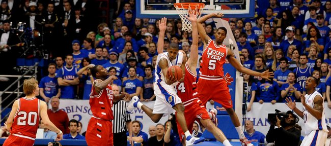 Kansas guard Mario Chalmers, center, draws a disproportionate amount of Texas Tech defenders on a first-half circus move. Chalmers missed, but KU's Darrell Arthur, right, followed with a slam in the Jayhawks' 109-51 Senior Night victory on Monday in Allen Fieldhouse. IN photos across the top, seniors, from left, Sasha Kaun, Darnell Jackson, Jeremy Case, Russell Robinson and Rodrick Stewart deliver traditional senior speeches after the blowout.