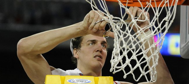 Kansas center Sasha Kaun gets his share of the net during the celebration Sunday, March 30, 2008 at Ford Field in Detroit.  Over the weekend Kaun signed with CSKA Moscow and will begin his professional basketball career in Russia.