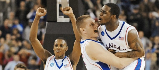 Kansas center Cole Aldrich hugs Sherron Collins as Mario Chalmers (15) hoists his fists as the buzzer sounds, signaling the Jayhawks' 59-57 victory over Davidson. Aldrich and Chalmers will face each other tonight in an NBA exhibition game at the Sprint Center.