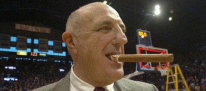Kansas athletic director Lew Perkins chews on a cigar after the KU men’s basketball team beat Texas in this file photo from March 3, 2007, at Allen Fieldhouse.