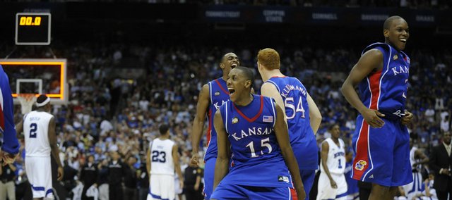 Kansas University's Mario Chalmers (15) leads the celebration as time runs out on the Jayhawks' 75-68 overtime victory over Memphis. Chalmers hit a three-pointer to tie it with 2.1 seconds left in regulation, and the Jayhawks went on to win their first national title in 20 years.
