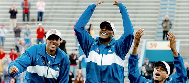 KU basketball players and national champions, from left, Mario Chalmers, Sherron Collins and Brandon Rush take in the atmosphere Tuesday of more than 25,000 fans at Memorial Stadium.