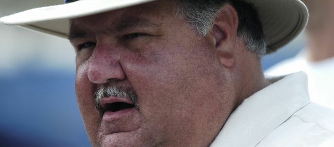 Kansas University head football coach Mark Mangino speaks with media members in this file photo from Saturday, Aug. 18, 2007 following a morning practice at Memorial Stadium. 
