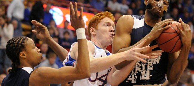 Kansas center Matt Kleinmann wrestles for ball control with Jackson State defenders Grant Maxey (32) and Jeremy Caldwell (44) during the first half Saturday, Dec. 6, 2008 at Allen Fieldhouse.