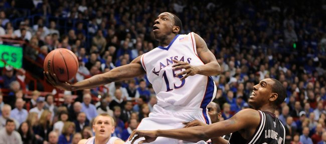 Kansas guard Tyshawn Taylor gets glides past Texas A&M forward David Loubeau for a bucket during the first half Monday, Jan. 19, 2009 at Allen Fieldhouse.