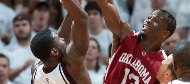 Texas A&M's Donald Sloan (15) goes up for a shot as Oklahoma's Willie Warren (13) defends during the second half of an NCAA college basketball game Saturday, Jan. 17, 2009 in College Station, Texas. Oklahoma won 69-63. 