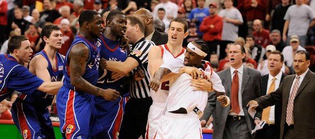 Kansas' Mario Little (23) and Nebraska guard Cookie Miller are restrained during a scuffle in the second half Wednesday, Jan. 28, 2009 at the Devaney Center in Lincoln. Both benches cleared to restrain the players.