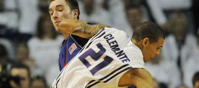 Kansas University guard Brady Morningstar takes an elbow from Kansas State’s Denis Clemente (21) during a 2009 game in Manhattan. 