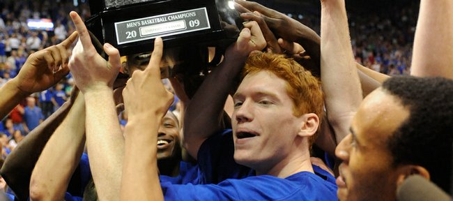 Senior Matt Kleinmann points at the Big 12 championship trophy after the Jayhawks defeated Texas 83-73 in KU's final regular-season game, and last game of the season in Allen Fieldhouse on Saturday, March 7, 2009.