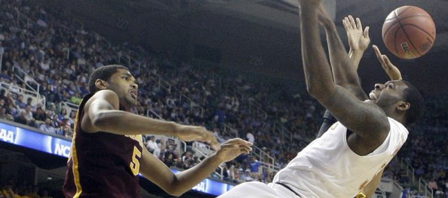 Texas' Damion James, right, is fouled by Minnesota's Devoe Joseph, left, during the second half of a first-round men's NCAA college basketball tournament game in Greensboro, N.C., Thursday, March 19, 2009.
