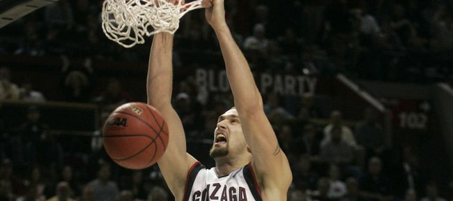 Gonzaga forward Josh Heytvelt, left, scores against Akron center Mike Bardo during the second half in the first round of the men's NCAA college basketball tournament in Portland, Ore., Thursday, March 19, 2009. Heytvelt scored 22 points as they beat Akron 77-64.