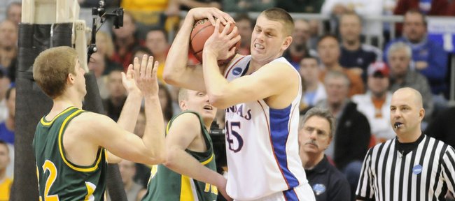 Kansas center Cole Aldrich rips a rebound away from North Dakota State guards Brett Winkelman, left, and Mike Nelson during the second half Friday, March 20, 2009 at the Metrodome in Minneapolis.
