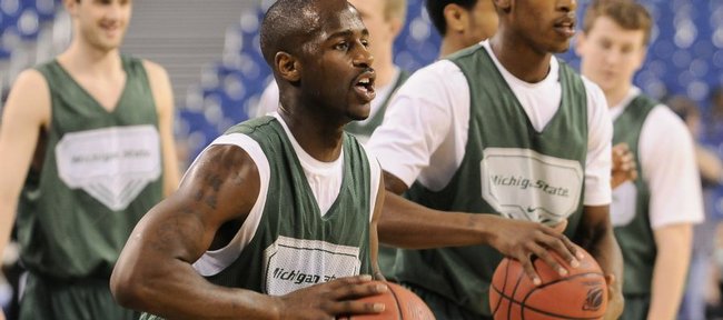 Michigan State guard Travis Walton, center, looks to pass during practice Thursday, March 26, 2009 at Lucas Oil Stadium in Indianapolis. At right is Spartans' guard Durrell Summers.