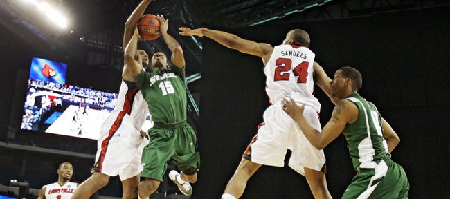 Michigan State's Durrell Summers (15) shoots against Louisville's Samardo Samuels (24) and Andre McGee, second from left,, in the first half of the NCAA Midwest Regional men's college basketball tournament final Sunday, March 29, 2009, in Indianapolis.