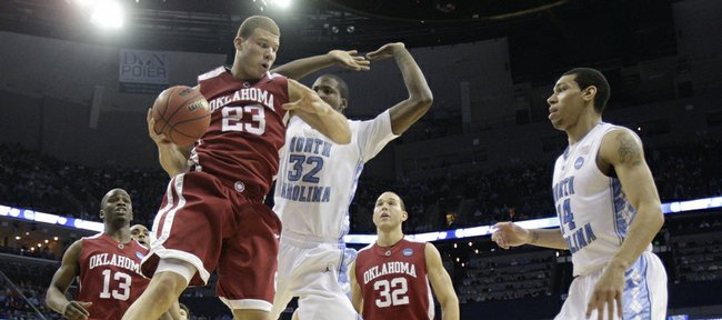 Oklahoma forward Blake Griffin (23) takes down a rebound ahead of North Carolina forward Ed Davis (32) in the first half of the men's NCAA tournament South Regional championship college basketball game in Memphis, Tenn., Sunday, March 29, 2009. Nearby are Oklahoma's Willie Warren (13) and Taylor Griffin (32) and North Carolina's Danny Green (14).