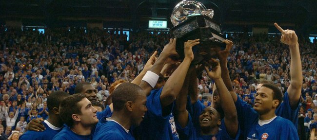 Kansas University basketball players hoist their newly-earned Big 12 regular season title trophy. The Jayhawks defeated Texas in March 2007 to take the regular season title outright and notch the program's 1,900th victory.