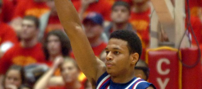 Kansas guard Brandon Rush raises a high fist as the Jayhawks walk off the court with a 68-64 win over Iowa State in overtime at Hilton Coliseum.