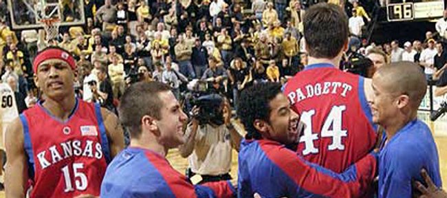 After the final buzzer, Kansas players mob KU freshman David
Padgett (44), congratulating him on hitting what proved to be the
game-winning shot with two seconds left.
