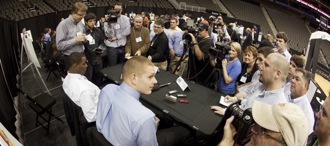 Kansas University center Cole Aldrich, seated at right, talks with a large group of media members about what he believes is a higher level of competition in the Big 12 Conference this year. At left is Sherron Collins, who also participated in Thursday’s Big 12 Media Day in Kansas City, Mo.